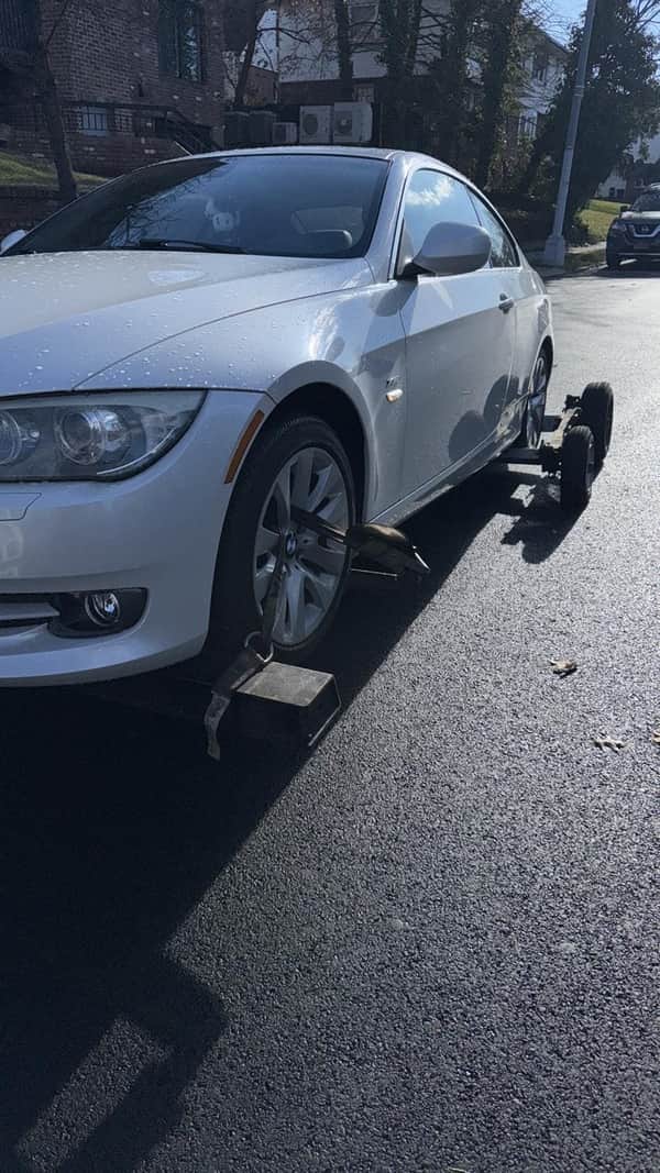 BMW coupe being towed by Jonuzi Towing